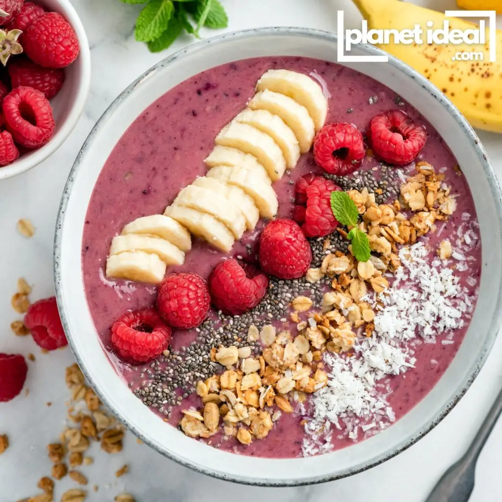 A colorful smoothie bowl topped with fresh fruits and seeds
