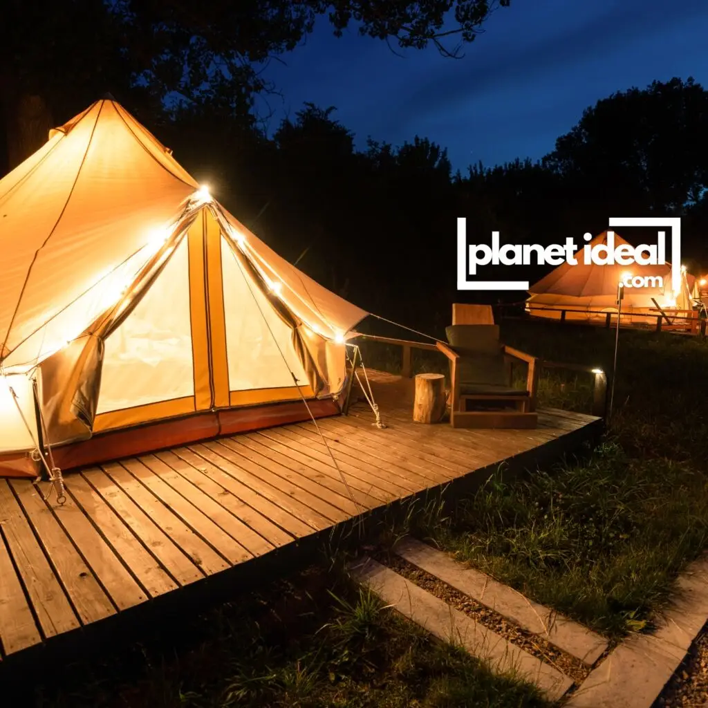 A cozy glamping tent with solar-powered lanterns, surrounded by forest or open fields.