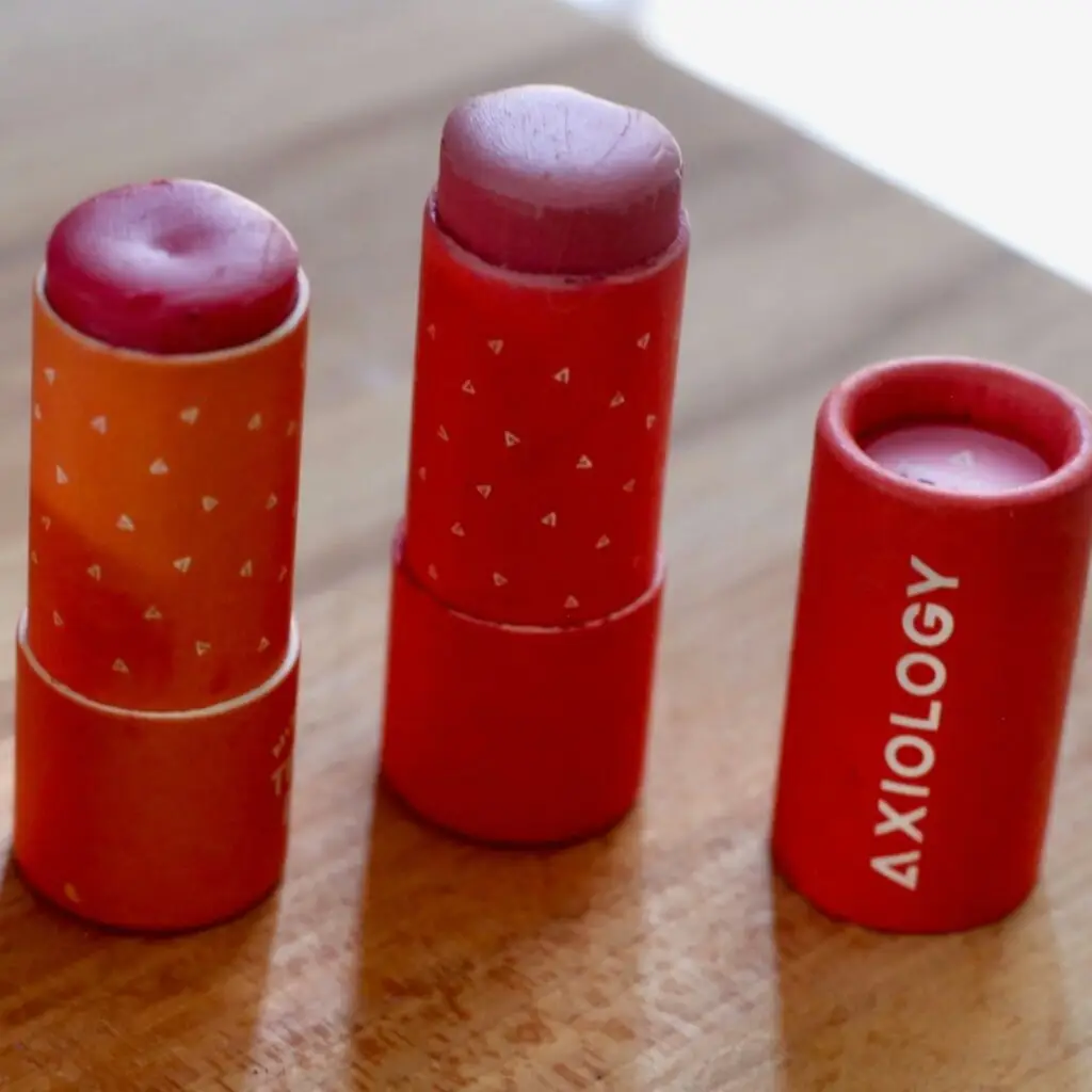 A creative shot of Axiology Balmies scattered on a natural wooden surface