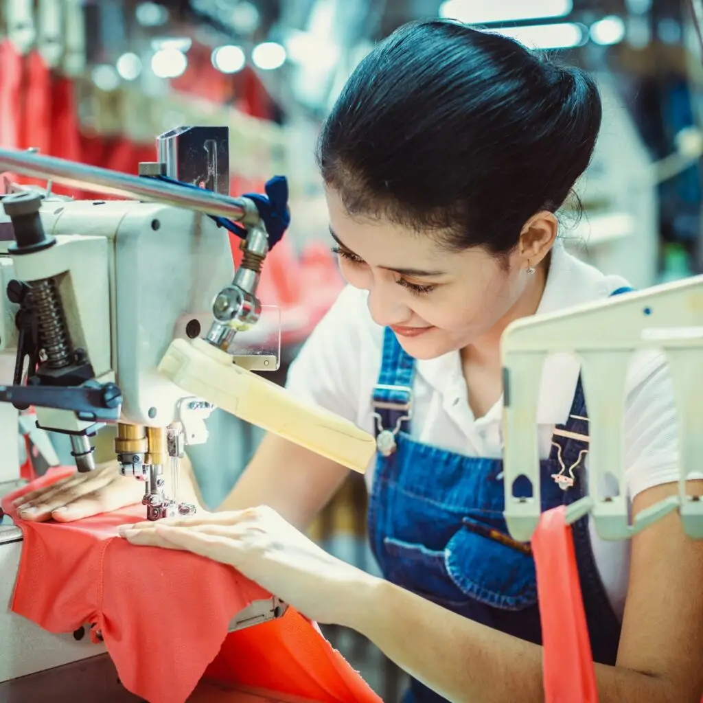 A factory worker crafting a garment in a clean, well-lit workshop, emphasizing ethical labor practices
