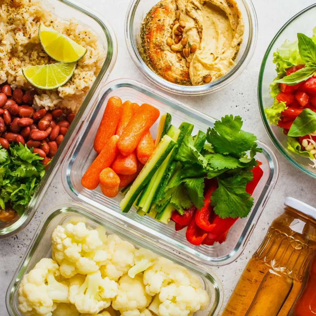 A lunch spread featuring food stored in colorful, sustainable containers