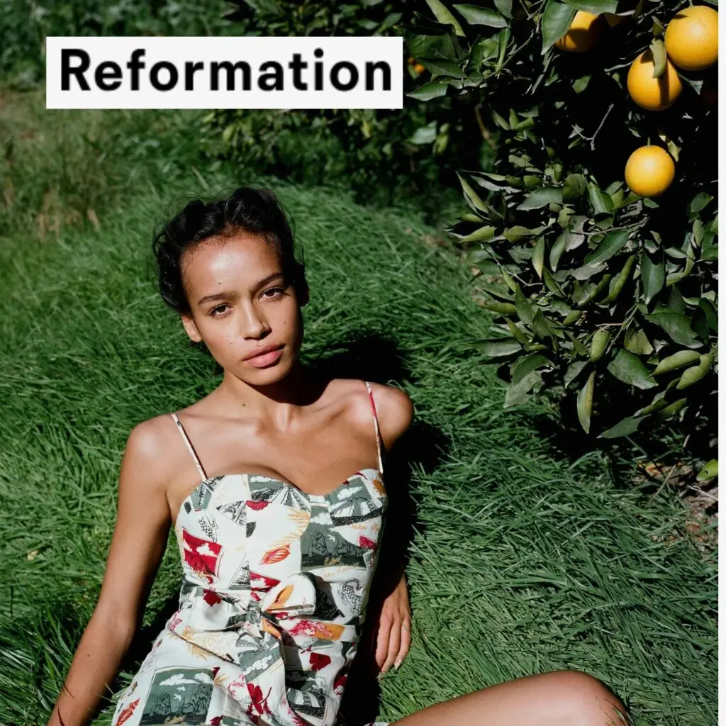 A model wearing a Reformation dress at an outdoor event