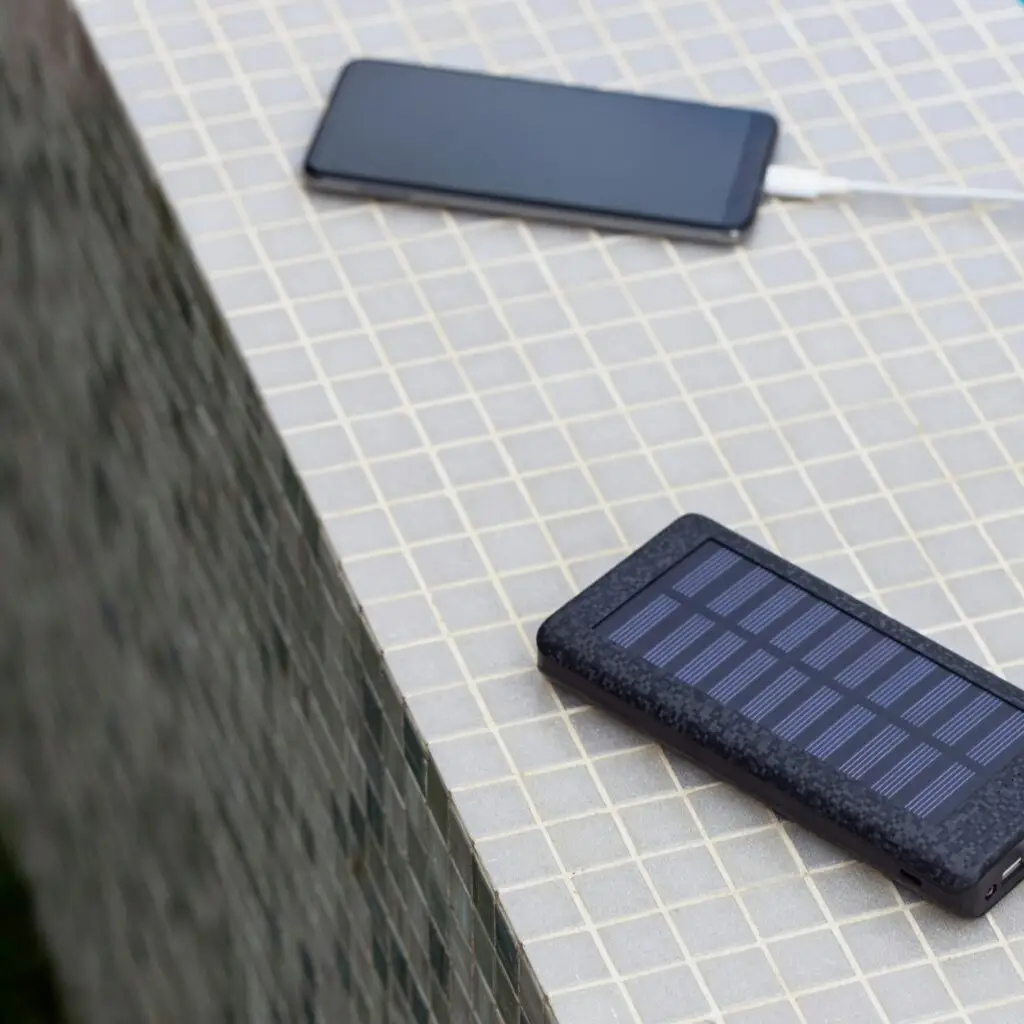 A portable solar charger set up on a sunny windowsill