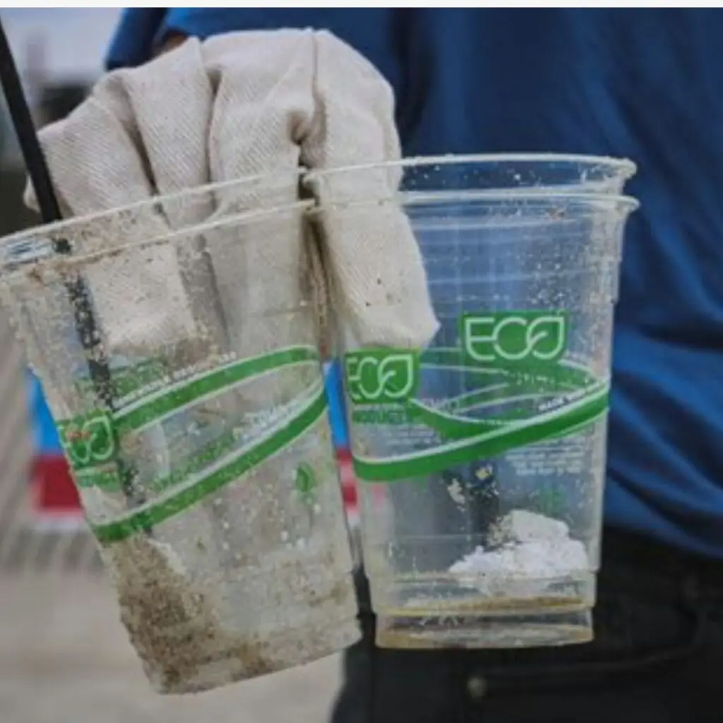 A product with a recycled label but a clear image of harmful production practices or excessive packaging behind it