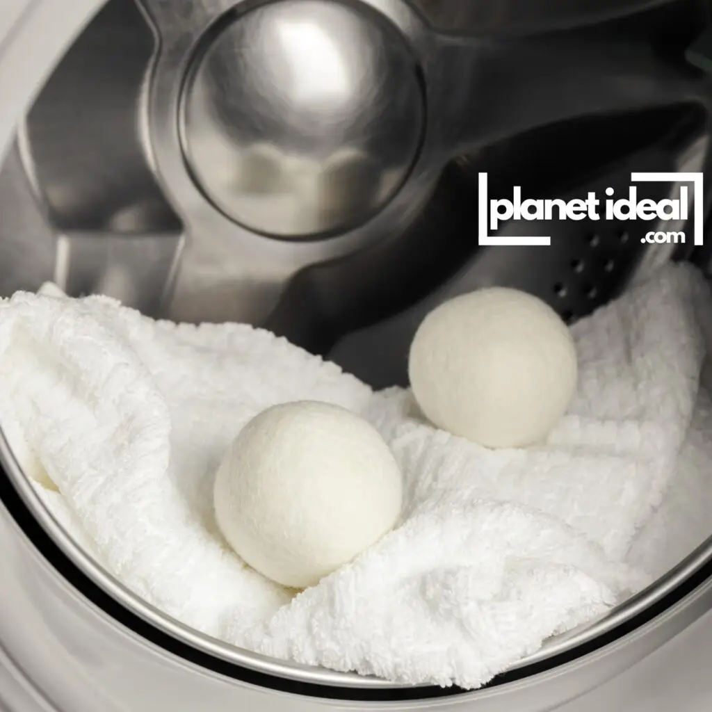 A set of wool dryer balls in a laundry filled with fresh, clean towels