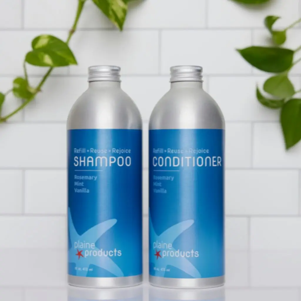 A sleek photo of Plaine Products bottles next to a sink