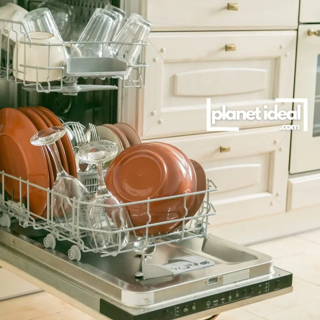 A stainless steel dishwasher loaded with neatly arranged dishes and glasses, ready for an eco-friendly wash cycle.