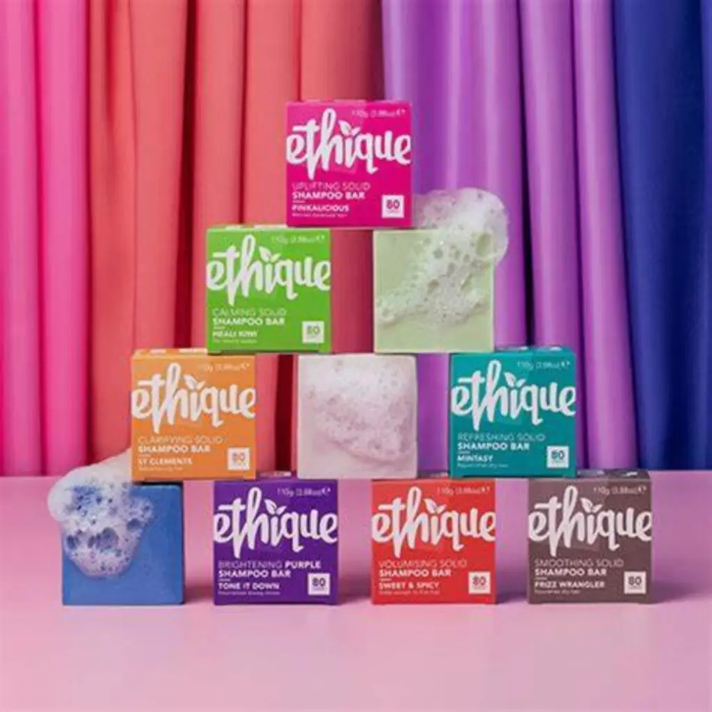 A vibrant image of Ethique shampoo bars neatly stacked on a bathroom shelf