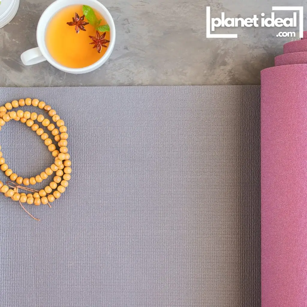A yoga mat with a cup of herbal tea on the floor, symbolizing a mindful morning.