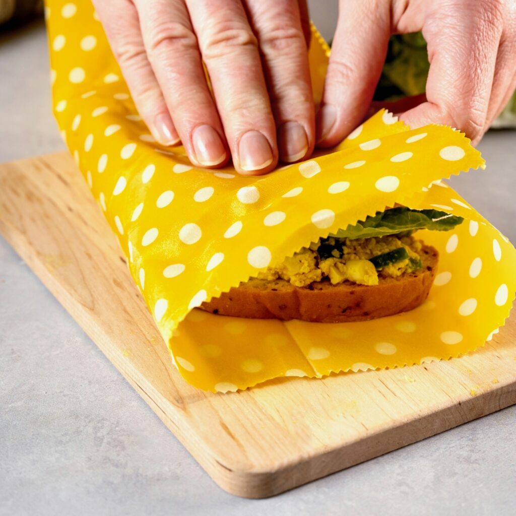 Colorful beeswax wrap covering sandwich