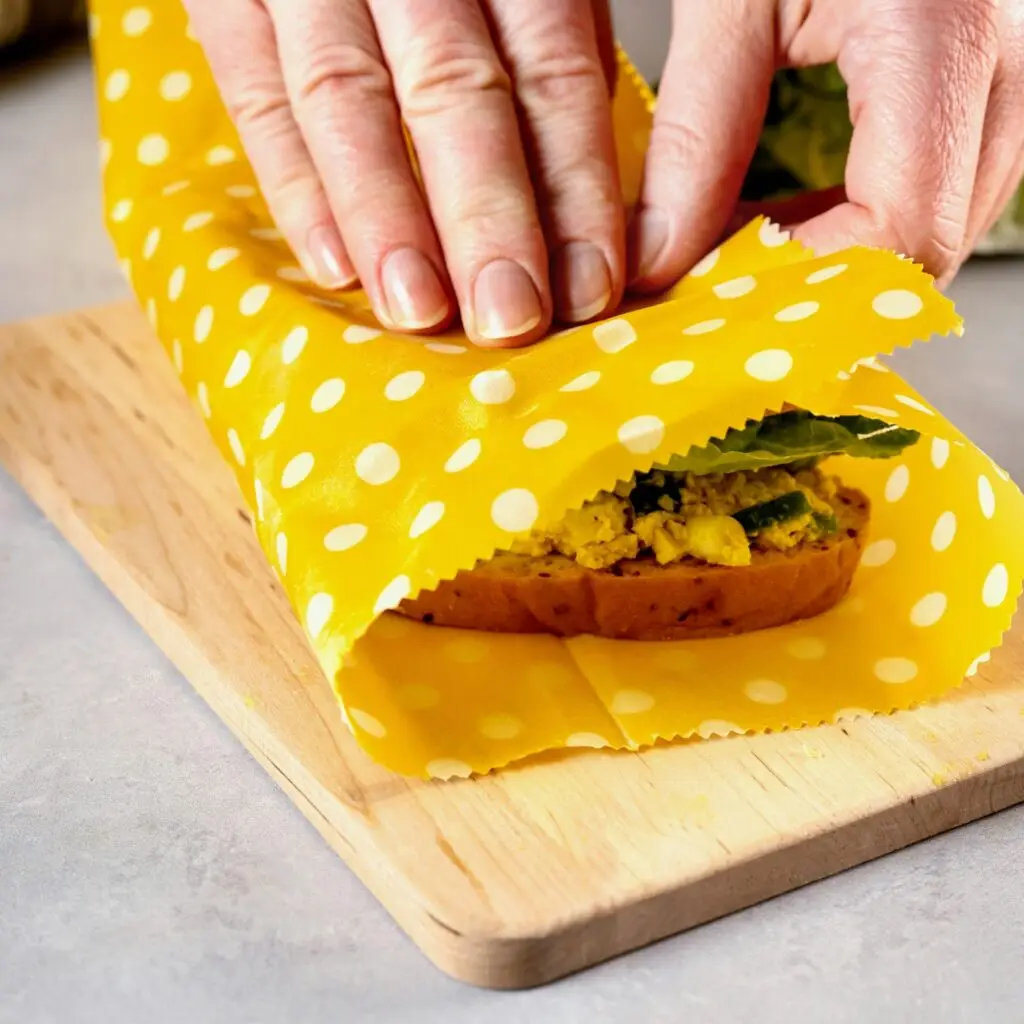 Colorful beeswax wrap covering sandwich
