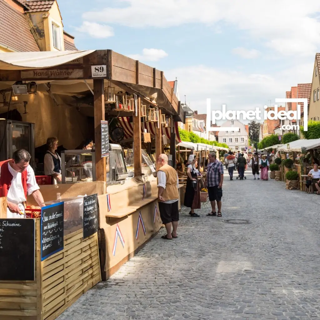 A lively scene from a local food festival, with stalls offering fresh produce and artisanal goods.