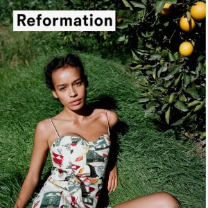 A model wearing a Reformation dress at an outdoor event
