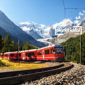 A stunning mountain view from a train window, showcasing snow-capped peaks